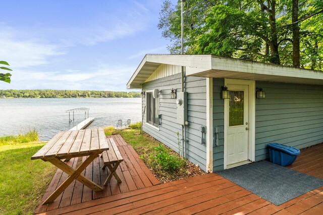 exterior space featuring a water view and an outdoor structure