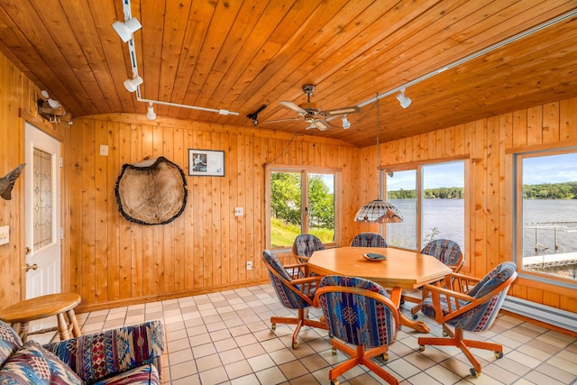 dining area with tile patterned flooring, a water view, rail lighting, and wood ceiling