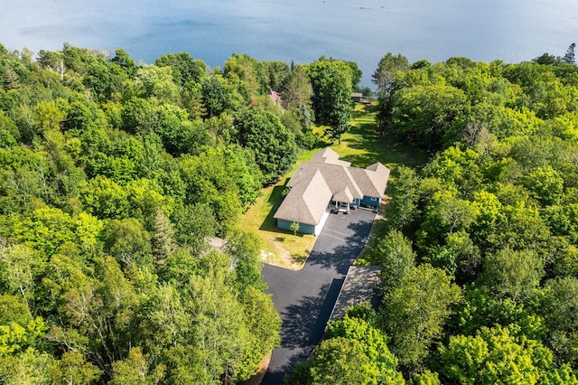 birds eye view of property with a view of trees