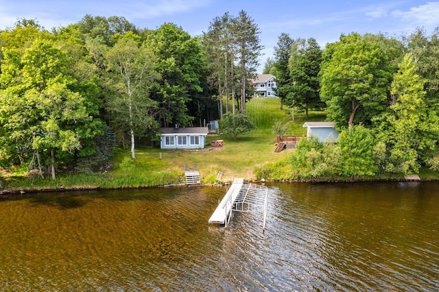 dock area with a water view and a lawn