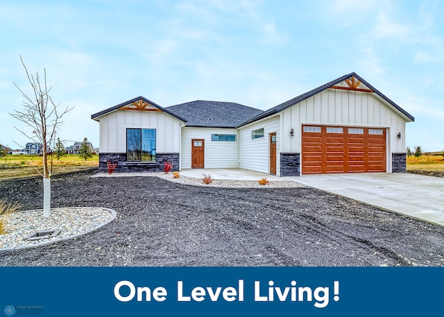 215 Emma Ct, Mapleton, ND 58059 - modern farmhouse featuring stone siding, board and batten siding, an attached garage, driveway, and a shingled roof