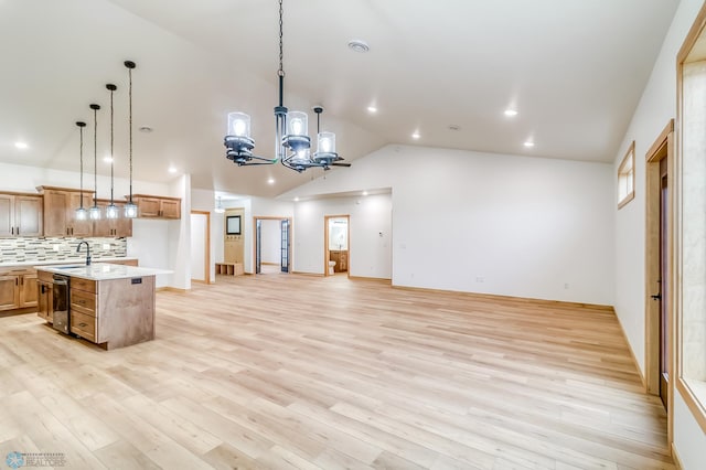 215 Emma Ct, Mapleton, ND 58059 - kitchen featuring dishwasher, light countertops, open floor plan, a chandelier, and vaulted ceiling