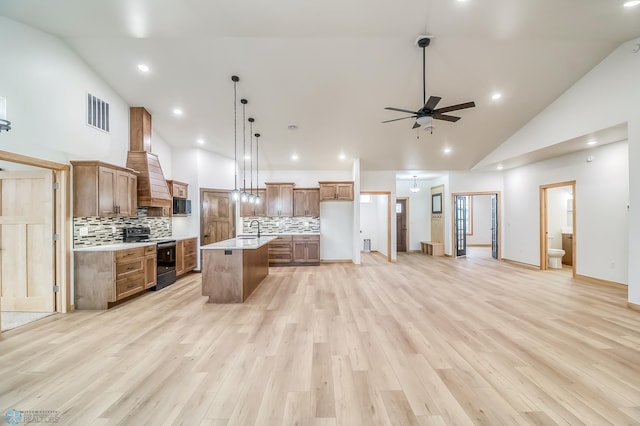 215 Emma Ct, Mapleton, ND 58059 - kitchen featuring stainless steel stove, high vaulted ceiling, open floor plan, backsplash, and light countertops