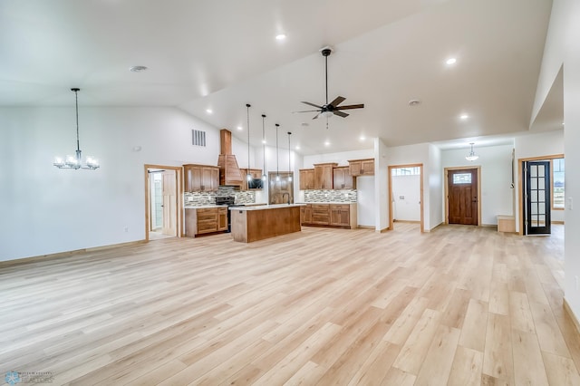 215 Emma Ct, Mapleton, ND 58059 - kitchen with open floor plan, high vaulted ceiling, brown cabinets, light countertops, and a center island