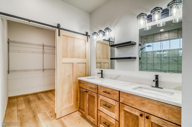 215 Emma Ct, Mapleton, ND 58059 - full bathroom with a shower stall, hardwood / wood-style floors, double vanity, and a spacious closet