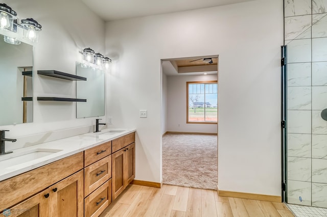 bathroom with vanity, hardwood / wood-style flooring, and a shower with door