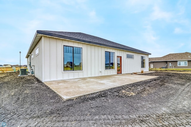 215 Emma Ct, Mapleton, ND 58059 - rear view of house featuring board and batten siding, central AC, a patio, and roof with shingles