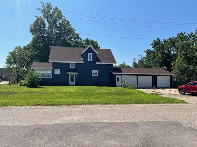 view of front of house with a garage and a front yard