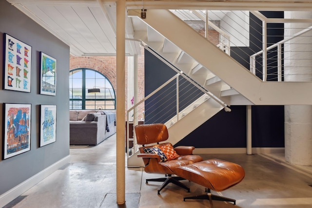 interior space with concrete floors and brick wall