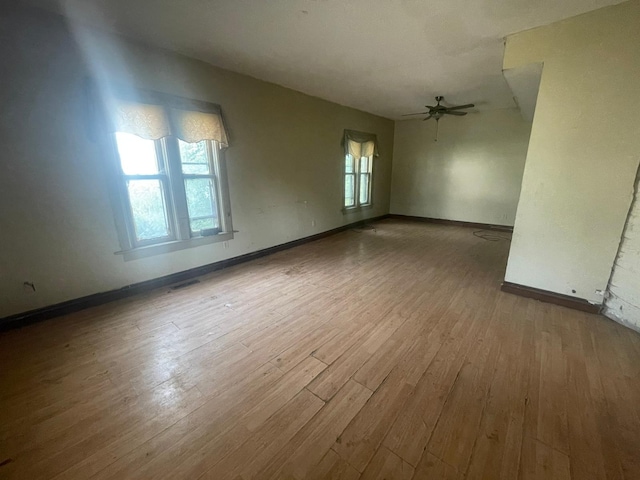 unfurnished room with ceiling fan and hardwood / wood-style floors