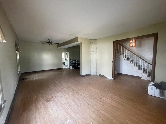 unfurnished living room featuring hardwood / wood-style flooring and ceiling fan