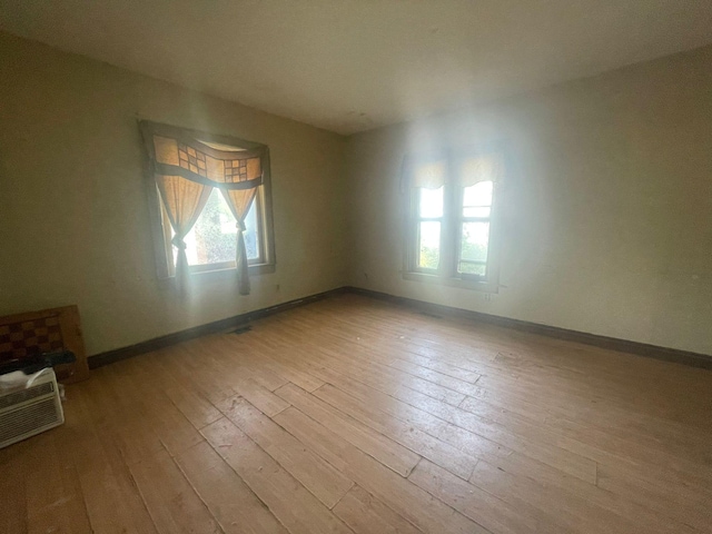 unfurnished room with light hardwood / wood-style floors