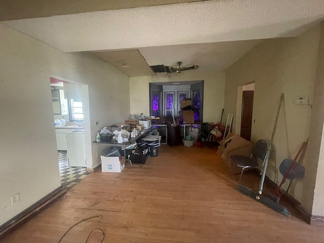 miscellaneous room with a textured ceiling and hardwood / wood-style floors