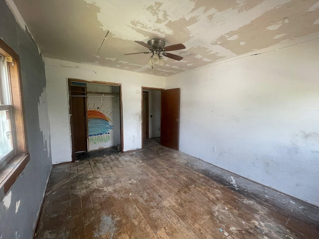 unfurnished bedroom featuring dark hardwood / wood-style floors and ceiling fan