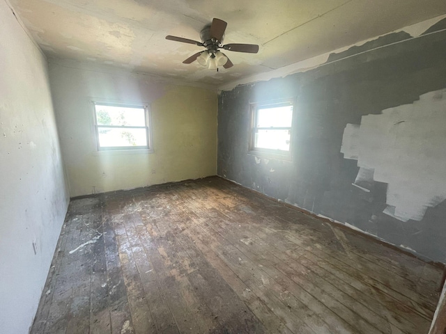 spare room featuring hardwood / wood-style floors, a wealth of natural light, and ceiling fan