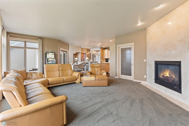 living room featuring carpet floors and a tile fireplace