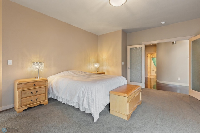 bedroom with dark colored carpet