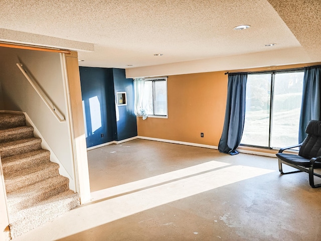 unfurnished room featuring concrete flooring and a textured ceiling