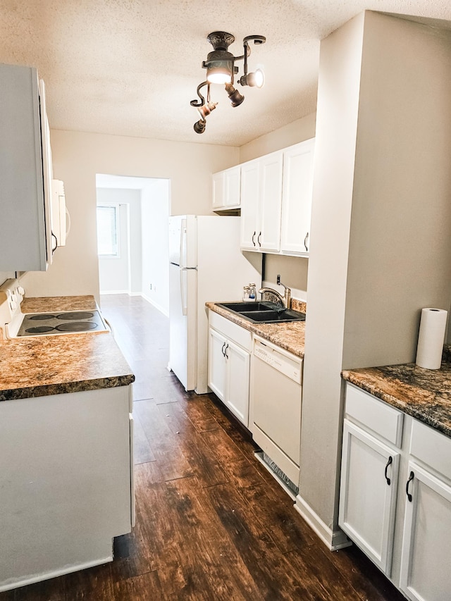 kitchen with a textured ceiling, white cabinets, and white appliances