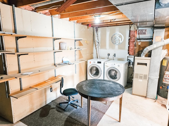 clothes washing area with gas water heater and washer and clothes dryer