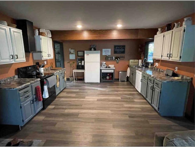 kitchen featuring black range with electric stovetop, white cabinetry, wood-type flooring, and white refrigerator