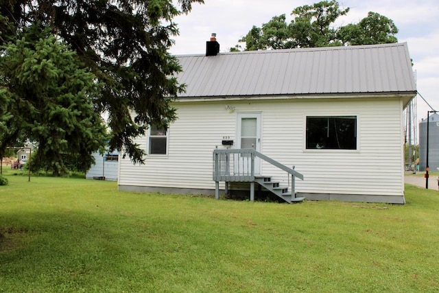 rear view of property with a lawn