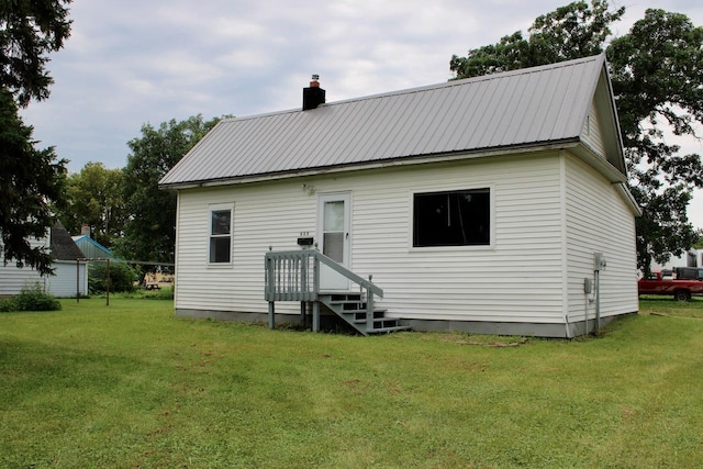 back of property with a lawn