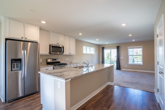 kitchen featuring dark hardwood / wood-style flooring, stainless steel appliances, a kitchen island with sink, sink, and white cabinets