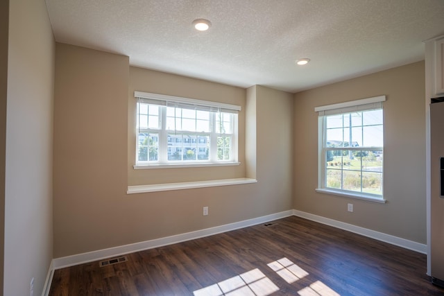 unfurnished room featuring a textured ceiling and dark wood-type flooring