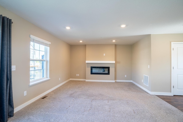 unfurnished living room featuring carpet