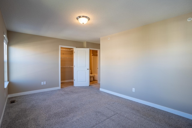 spare room with carpet and a textured ceiling