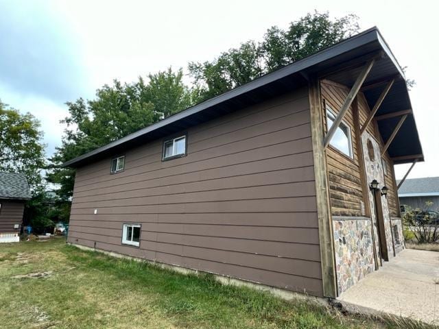 view of side of home featuring a yard