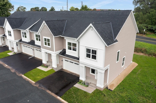 view of front of house with a front yard and a garage