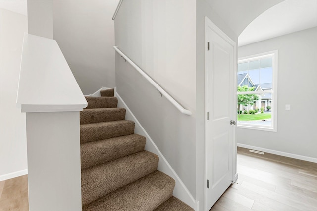 stairway featuring wood-type flooring