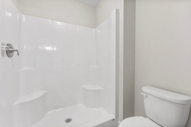 bathroom with toilet and walk in shower