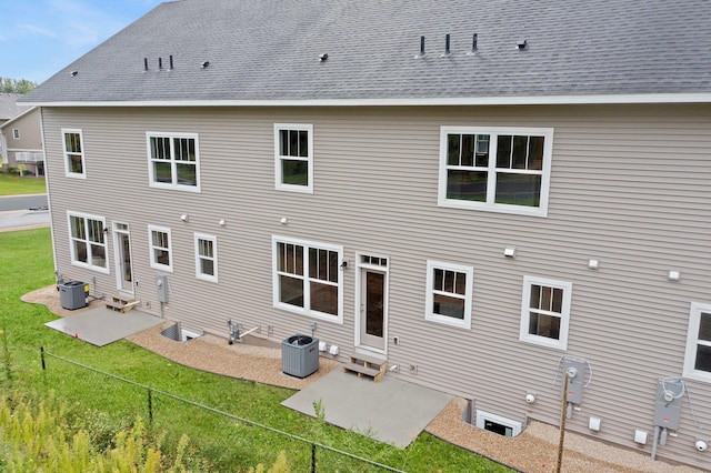 back of house featuring a patio area, a lawn, and central air condition unit