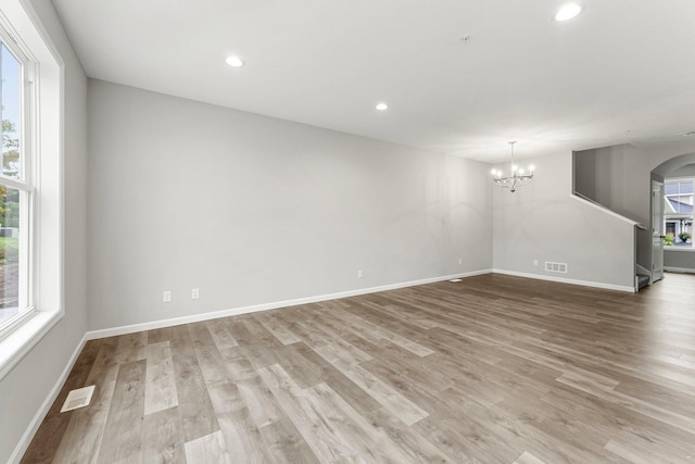 interior space featuring light hardwood / wood-style flooring and a notable chandelier