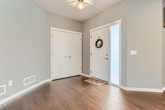 entrance foyer with dark hardwood / wood-style floors