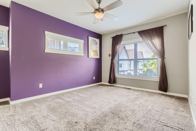 carpeted empty room featuring ceiling fan