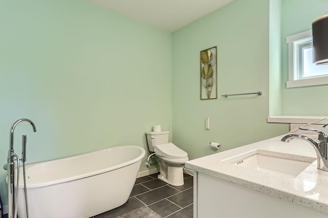 bathroom with tile patterned flooring, a tub, toilet, and vanity