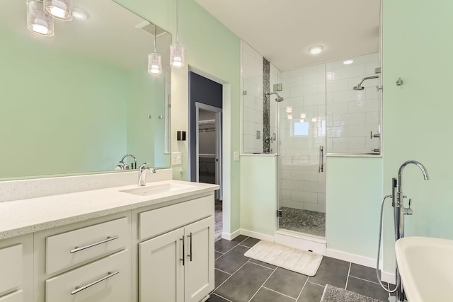 bathroom with tile patterned flooring, a shower with shower door, and vanity