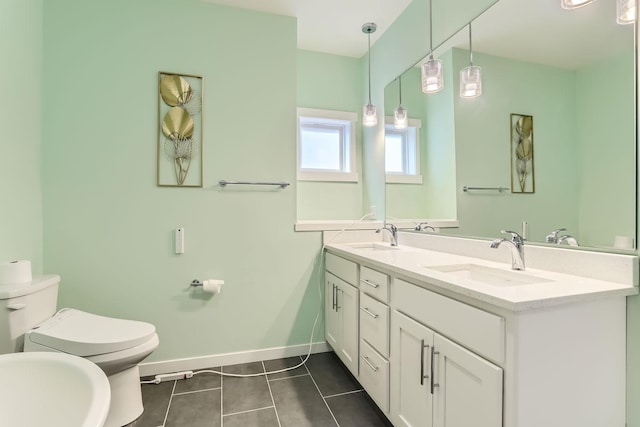 bathroom with tile patterned flooring, toilet, and dual bowl vanity