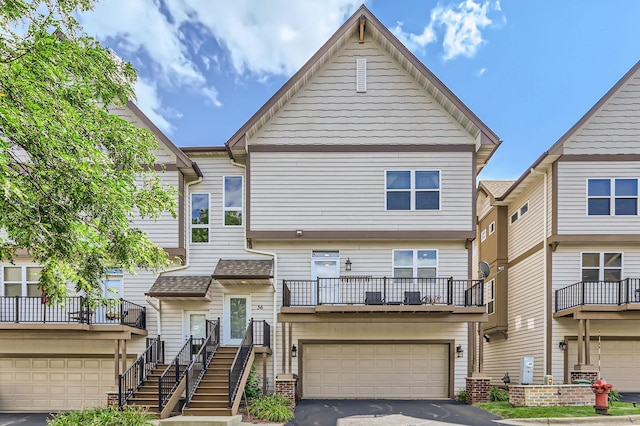 view of property featuring a balcony and a garage