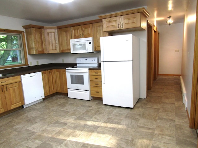 kitchen with sink, light tile patterned floors, and white appliances