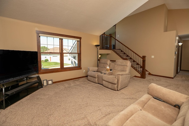 living room featuring vaulted ceiling, a textured ceiling, and light colored carpet