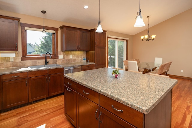 kitchen with a center island, pendant lighting, and sink