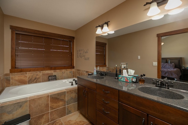 bathroom featuring vanity and a relaxing tiled tub