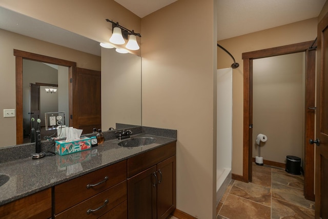 bathroom with walk in shower and vanity