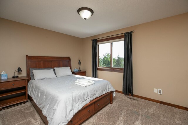 bedroom with light colored carpet