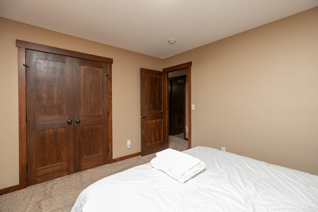 bedroom with a closet and light colored carpet